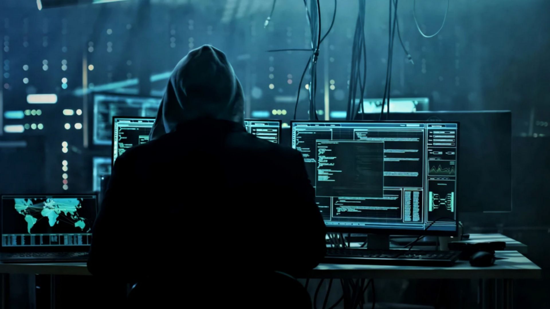 Photo of hacker looking at computer.