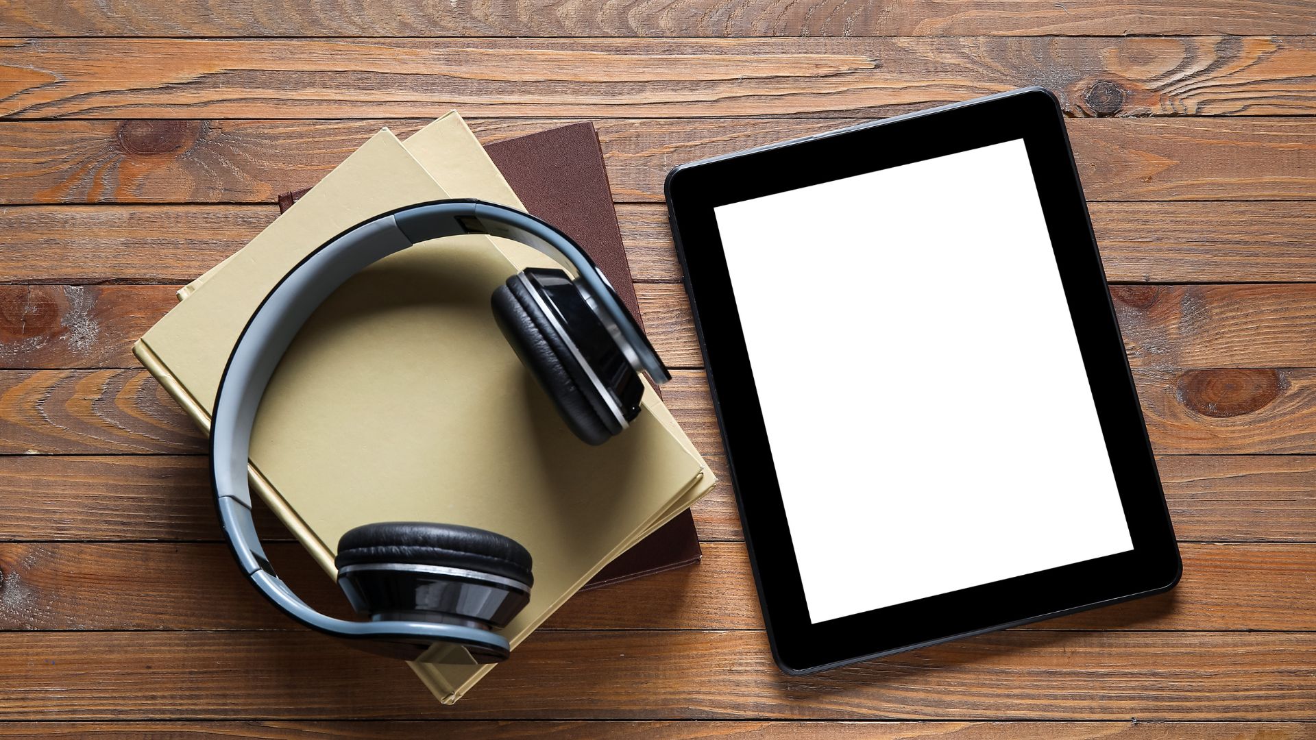 A pair of headphones, books and a tablet.